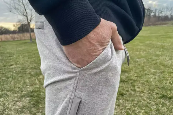 A person stands with their hands in the pocket of the Mack Weldon Ace Sweatpant