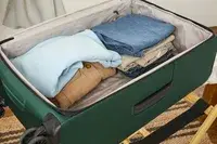 Folded clothing inside the Antler Soft Stripe Lightest Large Luggage