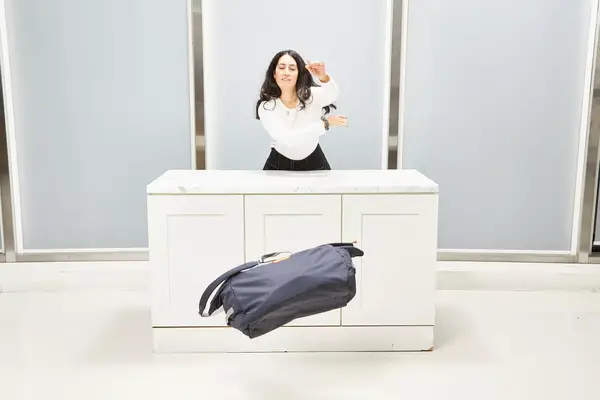 Person pushing the Bellroy Classic Weekender 45L off a counter