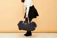 Person holding the Bellroy Classic Weekender 45L by its straps