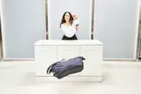 Person pushing the Bellroy Classic Weekender 45L off a counter