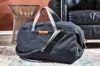 Bellroy Classic Weekender 45L displayed in front of a leather couch