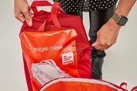 A person lifts the Samsonite Uplift Hardside Carry-on