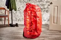 A person wheels the Samsonite Uplift Hardside Carry-on over stone pavers