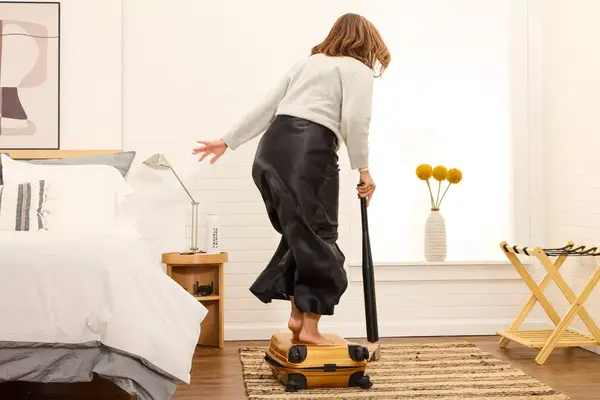 A person jumping on the Samsonite Proxis Global Carry-On Spinner