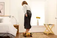 A person jumps on top of the Samsonite Proxis Global Carry-On Spinner