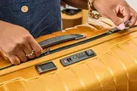 A person unzips the Samsonite Proxis Medium Spinner