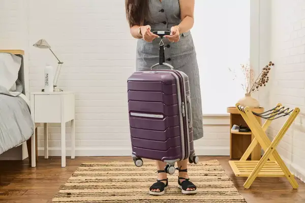 Samsonite Winfield 2 Hardside Luggage With Spinner Wheels displayed in front of a sofa