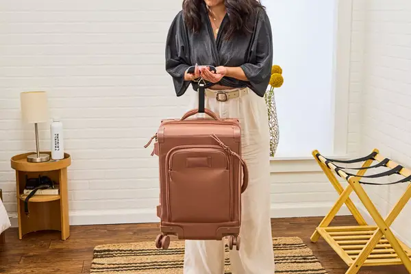 A person weighs the Dagne Dover Smaller Seattle Carry-on Luggage 20.5 Inches