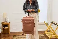 A person weighs the Dagne Dover Smaller Seattle Carry-on Luggage 20.5 Inches