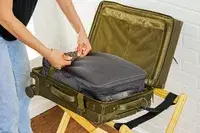 A person buckling the Dagne Doverr Seattle Carry On Rolling Luggage 20.5