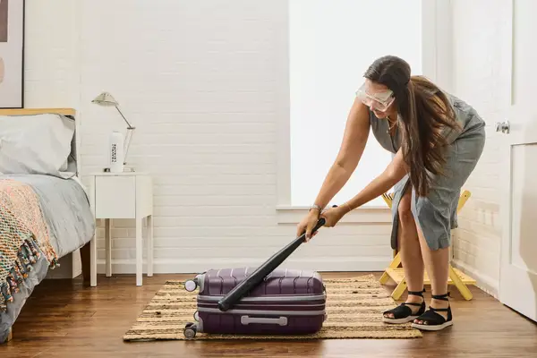 Person Hits Suitcase With Baseball Bat to Test Durability