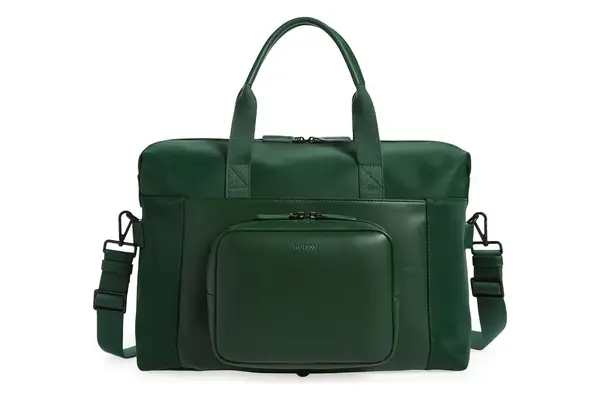 A person placing a passport and phone into the side pocket of the July Carry All Weekender