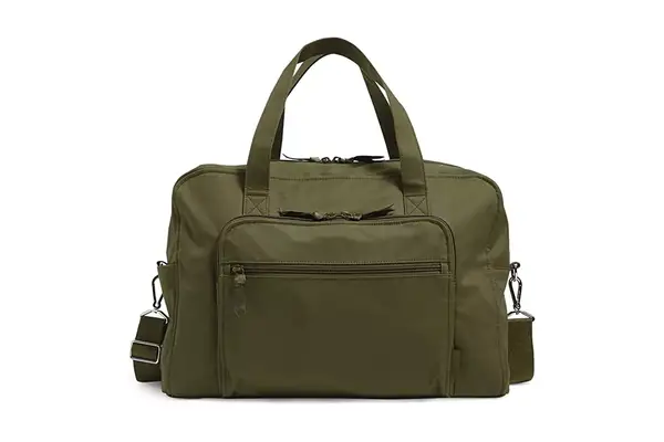 Hands packing clothing into the MZ Wallace Nik Duffel