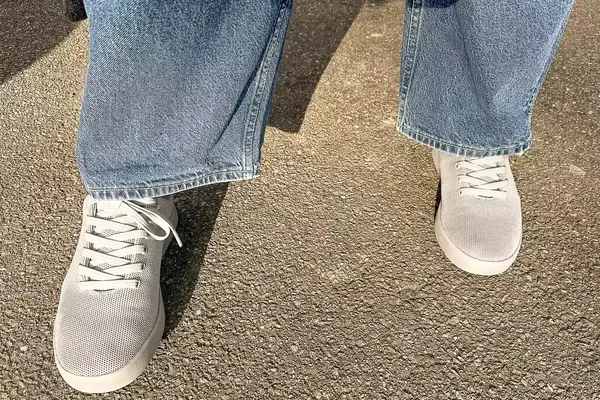 person standing on a concrete floor wearing Atoms Model 000