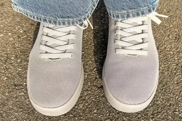 person standing on a concrete floor wearing Atoms Model 000