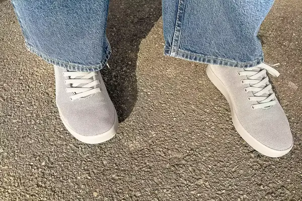 person standing on a concrete floor wearing Atoms Model 000