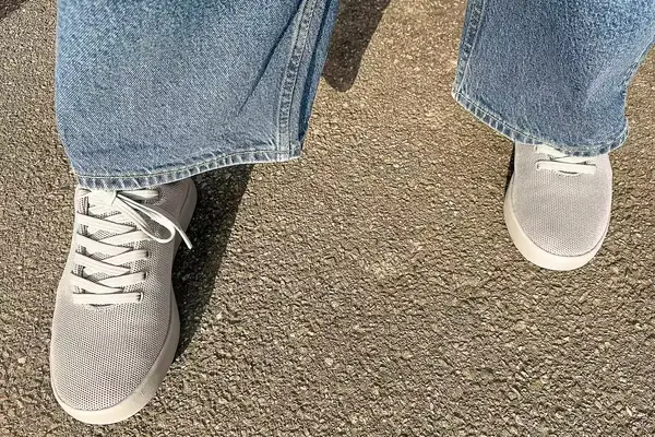person standing on a concrete floor wearing Atoms Model 000