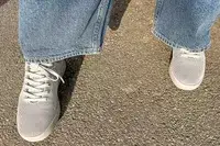 person standing on a concrete floor wearing Atoms Model 000