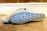 Pair of Atoms Model 000 on a wooden floor showing their soles