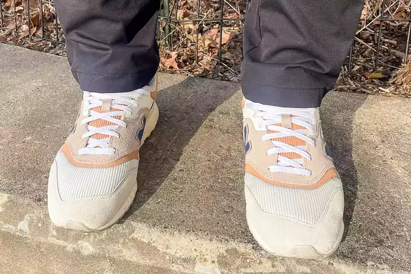person wearing New Balance 997H V1 Sneakers on a concrete floor