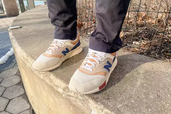 person wearing New Balance 997H V1 Sneakers on a concrete floor