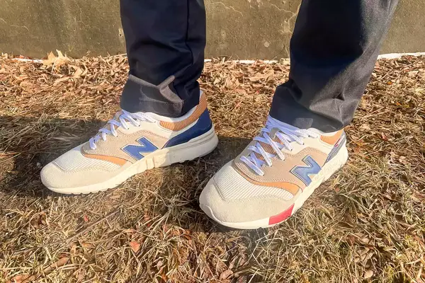 person wearing New Balance 997H V1 Sneakers on a grassy floor