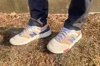 person wearing New Balance 997H V1 Sneakers on a grassy floor