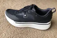 An AHNU Sequence 1 sneaker on carpet