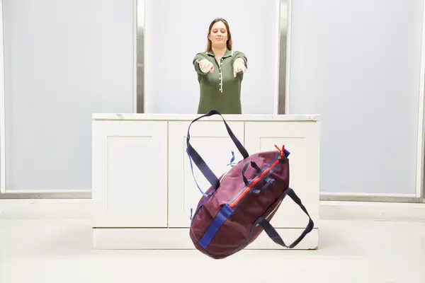 A person throwing the Cotopaxi Viaje bag to test durability