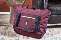 Cotopaxi Viaje 35L Weekender Bag - Cada Día on the floor next to furniture