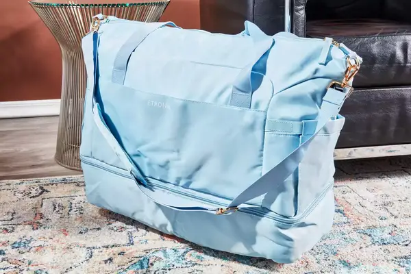 The ETRONIK Large Overnight Weekender 55L on a rug next to furniture