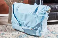 The ETRONIK Large Overnight Weekender 55L on a rug next to furniture