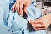 Hands using the charging port in the ETRONIK Large Overnight Weekender 55L