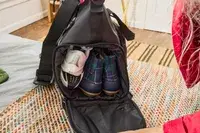 Shoes seen inside the Rains Large Texel Kit Bag