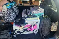 The Younglingz Ride On Suitcase packed in a car