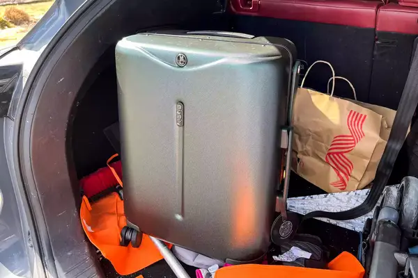 The MiaMily Carry-On packed into a trunk of a car