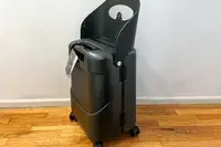 The MiaMily Carry-On on a wooden floor with seat up