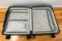 An opened, empty MiaMily Carry-On on a wooden floor