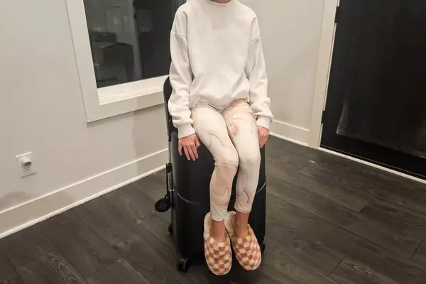 A person sitting on the MiaMily Check In in the corner of a room