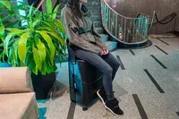 A person sitting on the MiaMily Check In