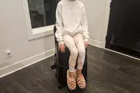 A person sitting on the MiaMily Check In in the corner of a room