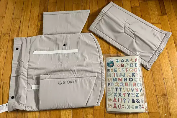 The ​​Stokke JetKids BedBox parts on a wooden floor