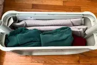Clothes packed in the ​​Stokke JetKids BedBox from an overhead angle