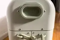 A close-up of a large push button on the ​​Stokke JetKids BedBox