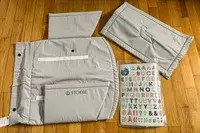 The ​​Stokke JetKids BedBox parts on a wooden floor