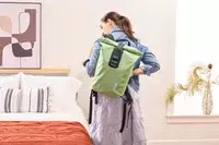 A person puts on the Ortlieb Velocity PS Pack 17L