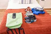 The Ortlieb Velocity PS Pack 17L on a bed with travel items