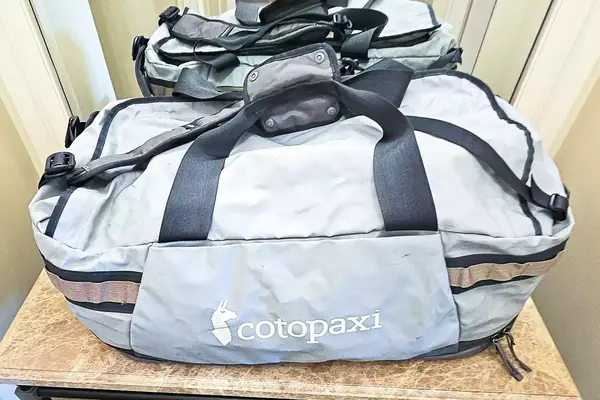 A Cotopaxi Allpa Getaway 70L Duffel resting on a table