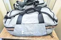 A Cotopaxi Allpa Getaway 70L Duffel resting on a table